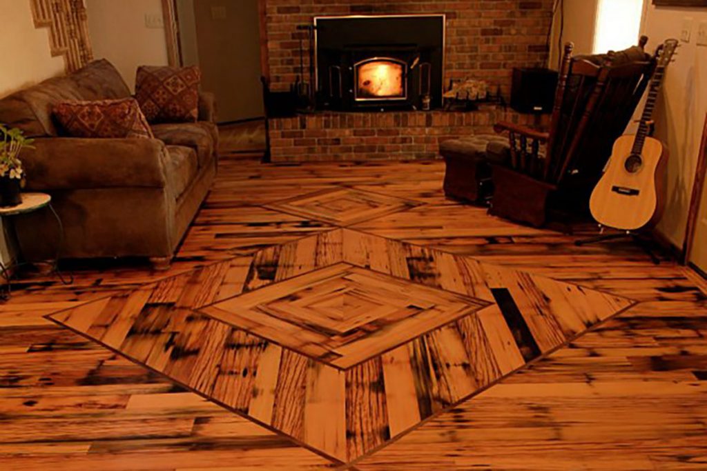 wooden floor of living area with fireplace, guitar, couch